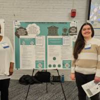 La Tonia Vernon and Maddy Post standing in front of their poster presentation